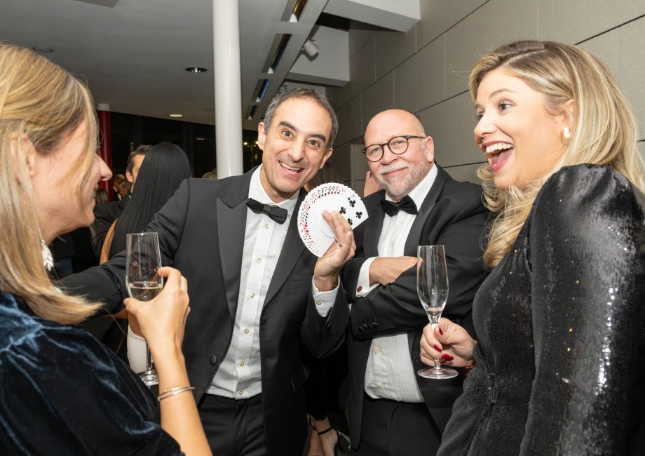 a picture of a close up magician amazing some attendees of the Surrey Property Awards 2023